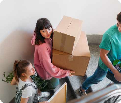 Roommates carrying moving boxes
