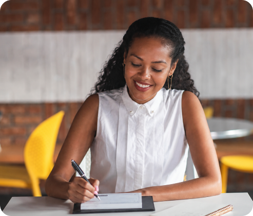 Resident writing at a desk